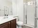 Clean bathroom with white shower and vanity, complemented by modern fixtures and gray wood-look flooring at , Las Vegas, NV 89178