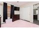 Bedroom featuring a TV, dresser, closet, and plush pink rug, with warm sunlight filtering through blinds at , Las Vegas, NV 89178