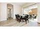 Dining area with a modern table set, sliding glass doors to the backyard, and sleek wood-look flooring at , Las Vegas, NV 89178