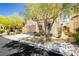 Lovely home showcasing a neatly maintained front yard with mature shade trees and an attached garage at , Las Vegas, NV 89178