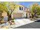 Two-story home featuring a neutral color scheme, integrated garage, and inviting front yard landscape at , Las Vegas, NV 89178