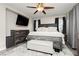 Bright main bedroom with wood-look floors, ceiling fan, and a mounted television at , Las Vegas, NV 89178