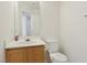 Bathroom featuring a white toilet, sink, and a large mirror at 1043 Monte De Oro Ave, Las Vegas, NV 89183