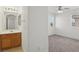 The bathroom showcases a wood vanity and a mirror with decorative lighting at 1043 Monte De Oro Ave, Las Vegas, NV 89183