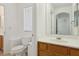 The bathroom features a toilet and a vanity with white countertop and a sink at 1043 Monte De Oro Ave, Las Vegas, NV 89183