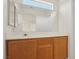 This bathroom features a large mirror and a wooden vanity, blending functionality with timeless design at 1043 Monte De Oro Ave, Las Vegas, NV 89183