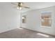Bright bedroom with a ceiling fan and two large windows at 1043 Monte De Oro Ave, Las Vegas, NV 89183