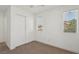 This bedroom features neutral carpet, white walls, and a closet with bifold doors at 1043 Monte De Oro Ave, Las Vegas, NV 89183