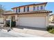 Inviting two-story home featuring a tile roof and a spacious two-car garage at 1043 Monte De Oro Ave, Las Vegas, NV 89183