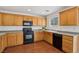 Well-lit kitchen featuring oak cabinets and essential appliances for cooking at 1043 Monte De Oro Ave, Las Vegas, NV 89183