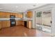 Functional kitchen with wood cabinets, granite counters, and sliding glass doors at 1043 Monte De Oro Ave, Las Vegas, NV 89183