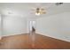 Bright living room with hardwood floors, ceiling fan, and access to staircase at 1043 Monte De Oro Ave, Las Vegas, NV 89183