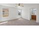 Spacious main bedroom with carpet, two windows, and a ceiling fan at 1043 Monte De Oro Ave, Las Vegas, NV 89183