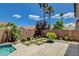 Backyard oasis with a pool, patio, lush plants, and palm trees at 10608 Trussell St, Las Vegas, NV 89141