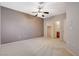 Comfortable bedroom with ceiling fan, neutral walls, and ensuite bathroom access for convenience and privacy at 10608 Trussell St, Las Vegas, NV 89141