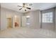 Bedroom with a window, neutral walls, ceiling fan, and doors to a closet and ensuite bathroom at 10608 Trussell St, Las Vegas, NV 89141