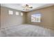 Bedroom featuring neutral paint and carpet and a large window offering backyard views at 10608 Trussell St, Las Vegas, NV 89141