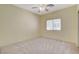 Bright, neutral bedroom with ceiling fan, window and soft carpet at 10608 Trussell St, Las Vegas, NV 89141