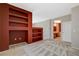 Bedroom with soft carpet, built-in shelving, and doorway to ensuite bathroom, offering comfort and convenience at 10608 Trussell St, Las Vegas, NV 89141