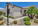 Charming single story home with desert landscaping, stepping stone walkway, and well-manicured lawn at 10608 Trussell St, Las Vegas, NV 89141