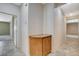 Hallway features tile flooring, a storage cabinet and doorway to a room with carpet at 10608 Trussell St, Las Vegas, NV 89141