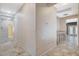 Spacious hallway featuring a sink and cabinets, and tan tile floors with a hallway to another room at 10608 Trussell St, Las Vegas, NV 89141