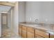 Hallway with sink, tile floors and wood cabinets, showcasing a practical space at 10608 Trussell St, Las Vegas, NV 89141