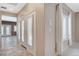 Neutral hallway featuring tile floors and a view of the shutter doors with view of the backyard at 10608 Trussell St, Las Vegas, NV 89141
