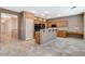 Bright kitchen features wood cabinets, stainless steel appliances and bar seating at 10608 Trussell St, Las Vegas, NV 89141