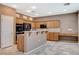 Kitchen boasts wood cabinetry, stainless steel appliances, tile floors and eat-in breakfast bar at 10608 Trussell St, Las Vegas, NV 89141