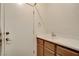 Bright laundry room featuring a single sink vanity and closet at 10608 Trussell St, Las Vegas, NV 89141