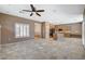 Bright living area showcases neutral tile flooring, and a view of the kitchen and hallway at 10608 Trussell St, Las Vegas, NV 89141