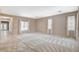 Spacious living room featuring carpeted floors, natural light, and neutral color palette at 10608 Trussell St, Las Vegas, NV 89141