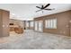Spacious living area features neutral tile flooring, and view of the kitchen and backyard at 10608 Trussell St, Las Vegas, NV 89141