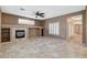 Open living room features tile flooring, fireplace, and view of shutter doors to the outside at 10608 Trussell St, Las Vegas, NV 89141
