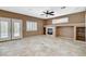 Bright open living room featuring tile flooring, a fireplace, and view of shutter doors to the outside at 10608 Trussell St, Las Vegas, NV 89141