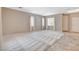 Large living room with carpet and tile flooring and natural light from multiple windows at 10608 Trussell St, Las Vegas, NV 89141