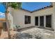Back patio with tile flooring that leads to a set of black framed glass double doors at 10608 Trussell St, Las Vegas, NV 89141