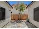 Backyard patio featuring decorative brick, tree and privacy wall, perfect for outdoor entertaining at 10608 Trussell St, Las Vegas, NV 89141