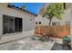 Private backyard patio area featuring tile flooring, mature tree, and comfortable seating at 10608 Trussell St, Las Vegas, NV 89141
