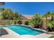 Backyard pool surrounded by desert landscaping and sunny blue skies at 10608 Trussell St, Las Vegas, NV 89141