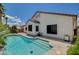 Gorgeous swimming pool with Baja step and water features surrounded by lush landscaping at 10608 Trussell St, Las Vegas, NV 89141