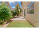 An inviting backyard features a stone patio, artificial grass, and a garden area at 10638 Pueblo Springs St, Las Vegas, NV 89183