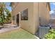 The backyard boasts a stone patio, lush green grass, and low-maintenance desert landscaping at 10638 Pueblo Springs St, Las Vegas, NV 89183