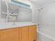 Well-lit bathroom with modern vanity, large mirror, and shower-tub combo with white tiles at 10638 Pueblo Springs St, Las Vegas, NV 89183