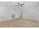 Large bedroom with carpet, ceiling fan, natural light and doorway leading to the ensuite bathroom at 10638 Pueblo Springs St, Las Vegas, NV 89183