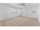 Spacious bedroom with carpeted floors, neutral walls, a ceiling fan, and bright windows at 10638 Pueblo Springs St, Las Vegas, NV 89183