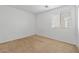 A clean, bright bedroom with neutral carpet and a large window allowing ample natural light to fill the space at 10638 Pueblo Springs St, Las Vegas, NV 89183