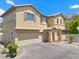 Two-story home boasting a stucco exterior, arched entryway, and a two-car garage, complementing its attractive design at 10638 Pueblo Springs St, Las Vegas, NV 89183