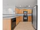 Well-equipped kitchen featuring wood cabinets, granite countertops, and stainless steel appliances, making cooking a delight at 10638 Pueblo Springs St, Las Vegas, NV 89183